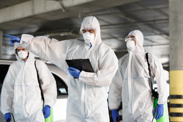 Men in virus protective suits enclosing the quarantine zone