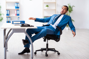 Young male employee in work accident concept
