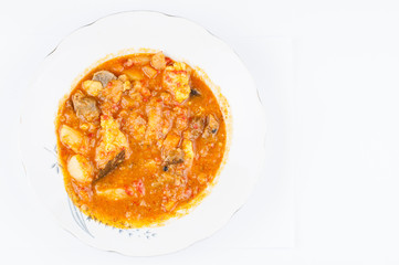 Cooked dish on a plate isolated on white background