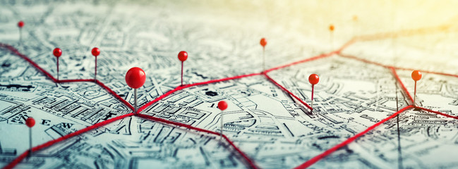 Routes with red pins on a city map. Concept on the  adventure, discovery, navigation,...