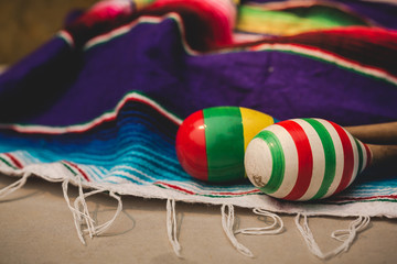 Fototapeta na wymiar Mexican maraca put on colorful blanket