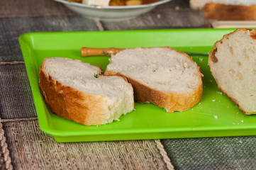 Cooked dish on a plate and bread set on a table