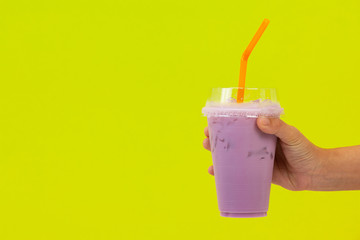 purple beverage and purple straw on yellow background