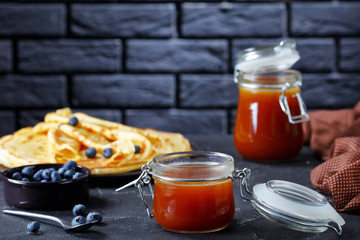 hot buttermilk syrup in glass jars, close-up