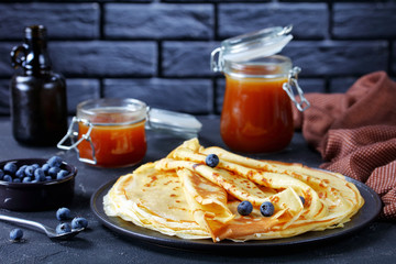 freshly cooked crepes on a black plate