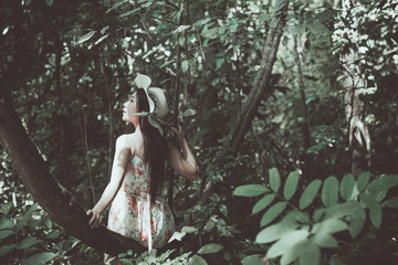 Fototapeta premium vintage picture of beautiful woman sitting on tree in the park