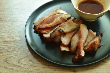 grilled slice pork neck dipping spicy sauce on plate