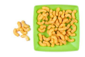 Salty snacks in green plate isolated on white background.Copy space