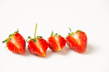 Cut in half strawberries on a white background