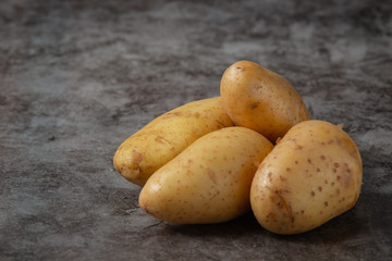 potatoes combined pile on gray floor