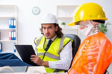 Funny construction business meeting with boss and skeletons