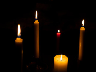 Burning candles with a red candle