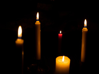 Burning candles with focus on the red candle