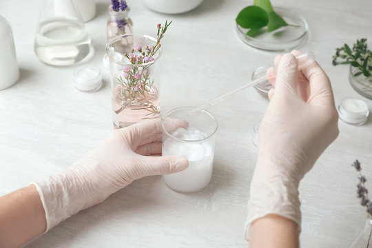 Scientist developing cosmetic product in laboratory, closeup