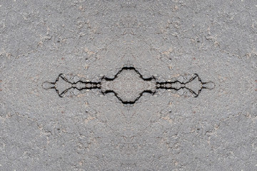Fototapeta na wymiar Symmetrical image from a photo of an asphalt road with a cracked surface. Abstract background for lettering or design.
