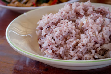 Rice berry on dish on wooden table