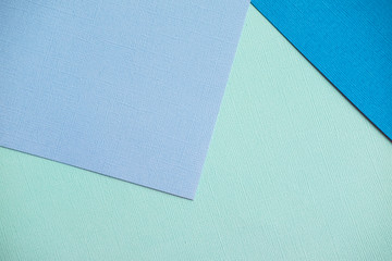 Mixing blue and turquoise design paper. The view from the top.