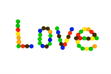 The word love is laid out from round candies
