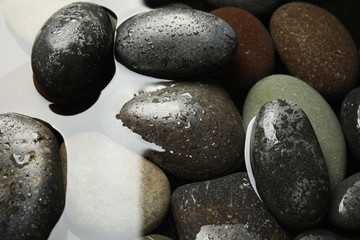 Fototapeta na wymiar Pile of stones in water as background, closeup. Zen lifestyle