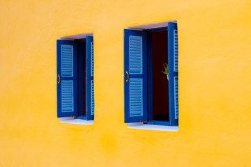 Blue wooden window on the yellow background