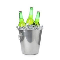 Metal bucket with bottles of beer and ice cubes isolated on white