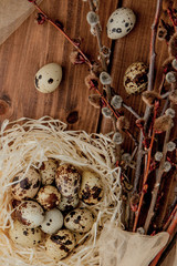 Flat lay composition of quail eggs and card with text Happy Easter on wooden table. Top view.
