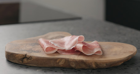 prosciutto ham on wood board