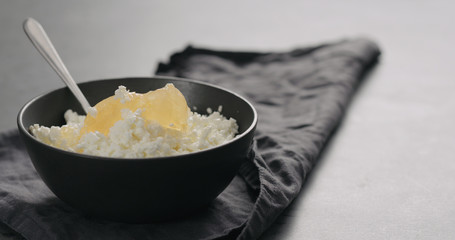 lemon marmalade with cottage cheese in black bowl closeup