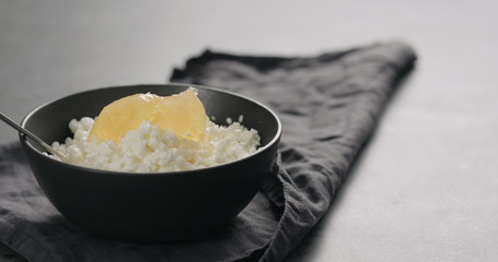 lemon marmalade with cottage cheese in black bowl closeup
