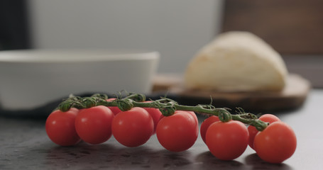 cherry tomatoes branch on conrete countertop