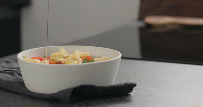 seasoning salad with cherry tomatoes, mixed grens and cheese from white bowl