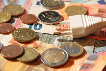 a plug with eurobanknotes and small money