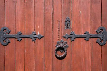 Old Wooden Door With Rounded Iron Handles. Oak colors.