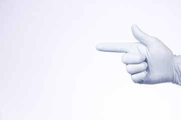 A gun sign by right man hand in a white medical glove on a white background
