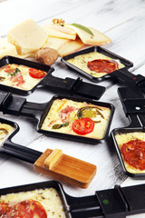 Delicious traditional Swiss melted raclette cheese on diced boiled or baked potato.