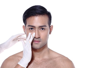 Asian man want to check eye, nose, eyebrow, forehead, cheek, jawline before plastic surgery, touch by nurse's rubber gloves, studio lighting white background copy space for text logo