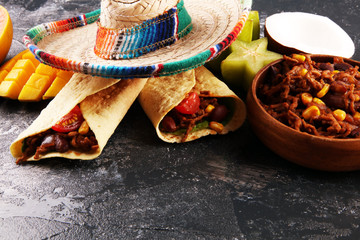 Mexican food mix in colorful colors. sombrero and mexican food with tacos