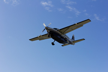 Fototapeta na wymiar Airplane in the blue sky. Small plane in the open sky.