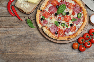 Delicious pizza Diablo on wooden table, flat lay. Space for text