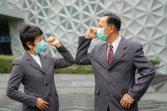 Old Asian Business People Greeting Togather By New Methode With Mask For Prevent Covid 19