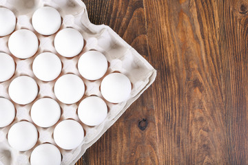 Fresh farm eggs on a wooden rustic background, close up.Chicken eggs, copy space, top