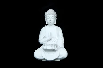 Tuinposter The white statue of the calm sitting buddha isolated in a black background.  © shootingtheworld