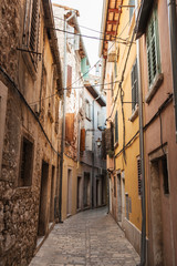 Fototapeta na wymiar 2019, Europe, Croatia, Rovinj. Architecture of old town, lonely narrow street of Rovinj. Travel, adventure concept. City background.