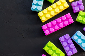 Colorful toy bricks  ob black table
