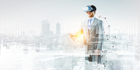 Businessman in VR glasses . Mixed media