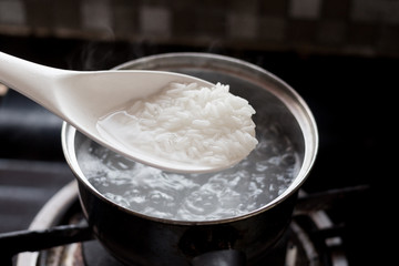Fototapeta na wymiar Cooked rice in pot with spoon