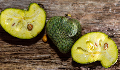 Fresh hybrid fruit of atemoia (Annona cherimolia Mill x Annona squamosa L.) in matedes on wooden background