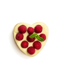 Heart shaped cheesecake with raspberry isolated on white. Top view