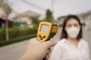 Digital thermometer checking temperature. Woman