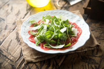 Beef carpaccio with arugula and Parmesan cheese